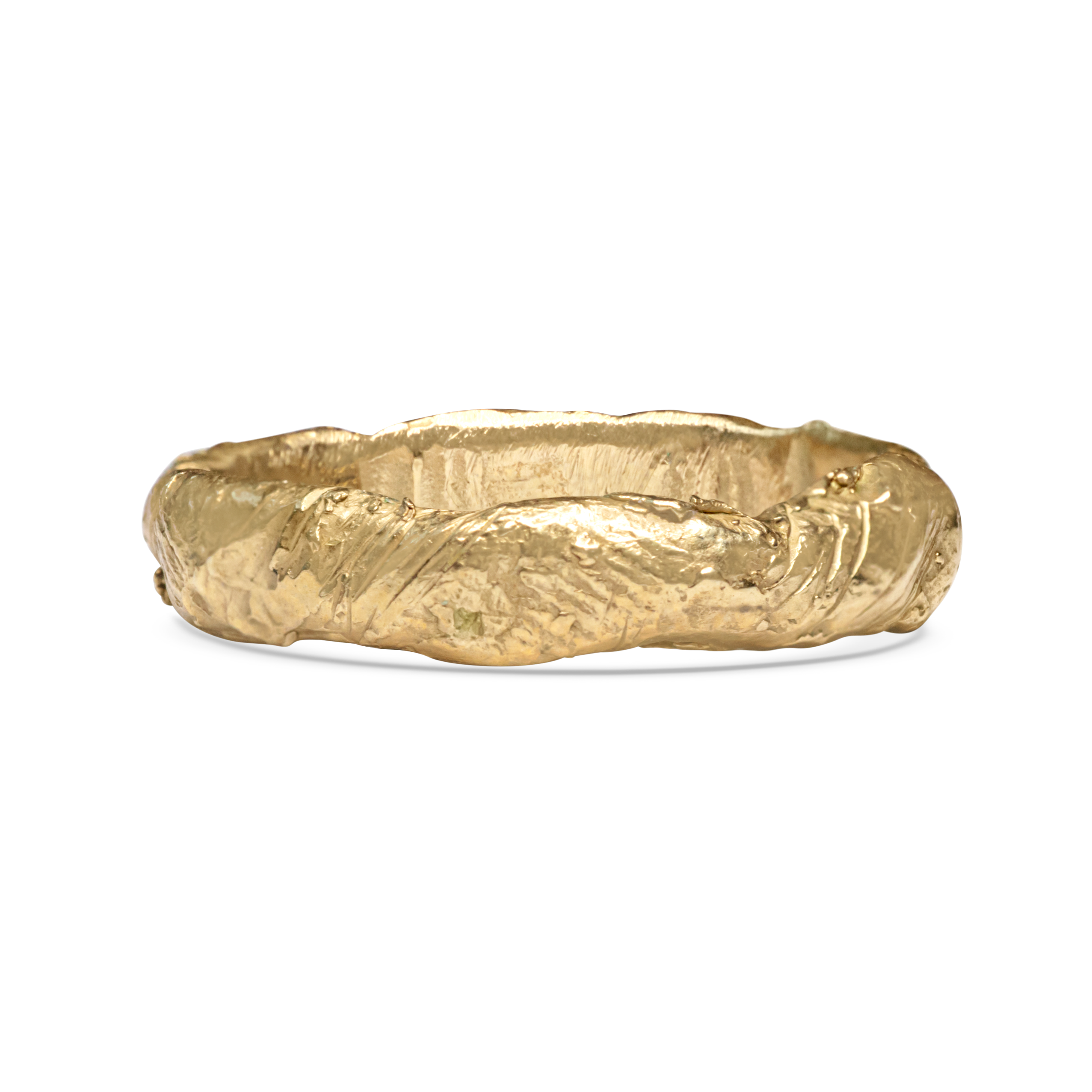 Gold ring with a textured surface on a white background