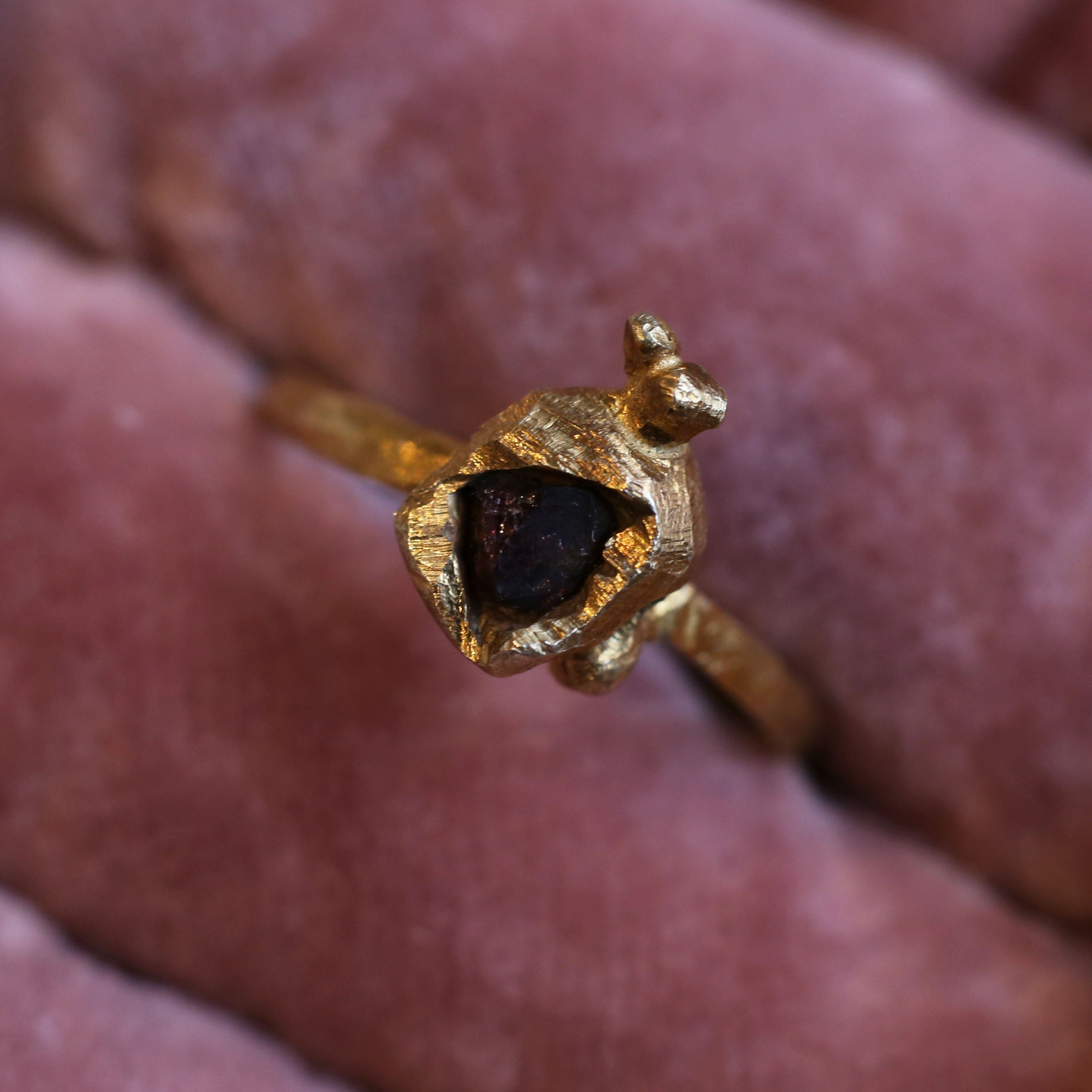 Gold plated sterling silver ring set with broken garnet, with organic textures
