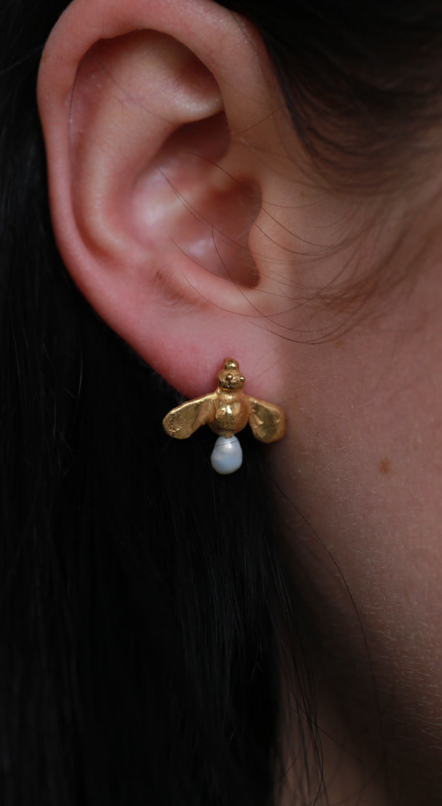 model wears the honey drop stud earrings in gold vermeil