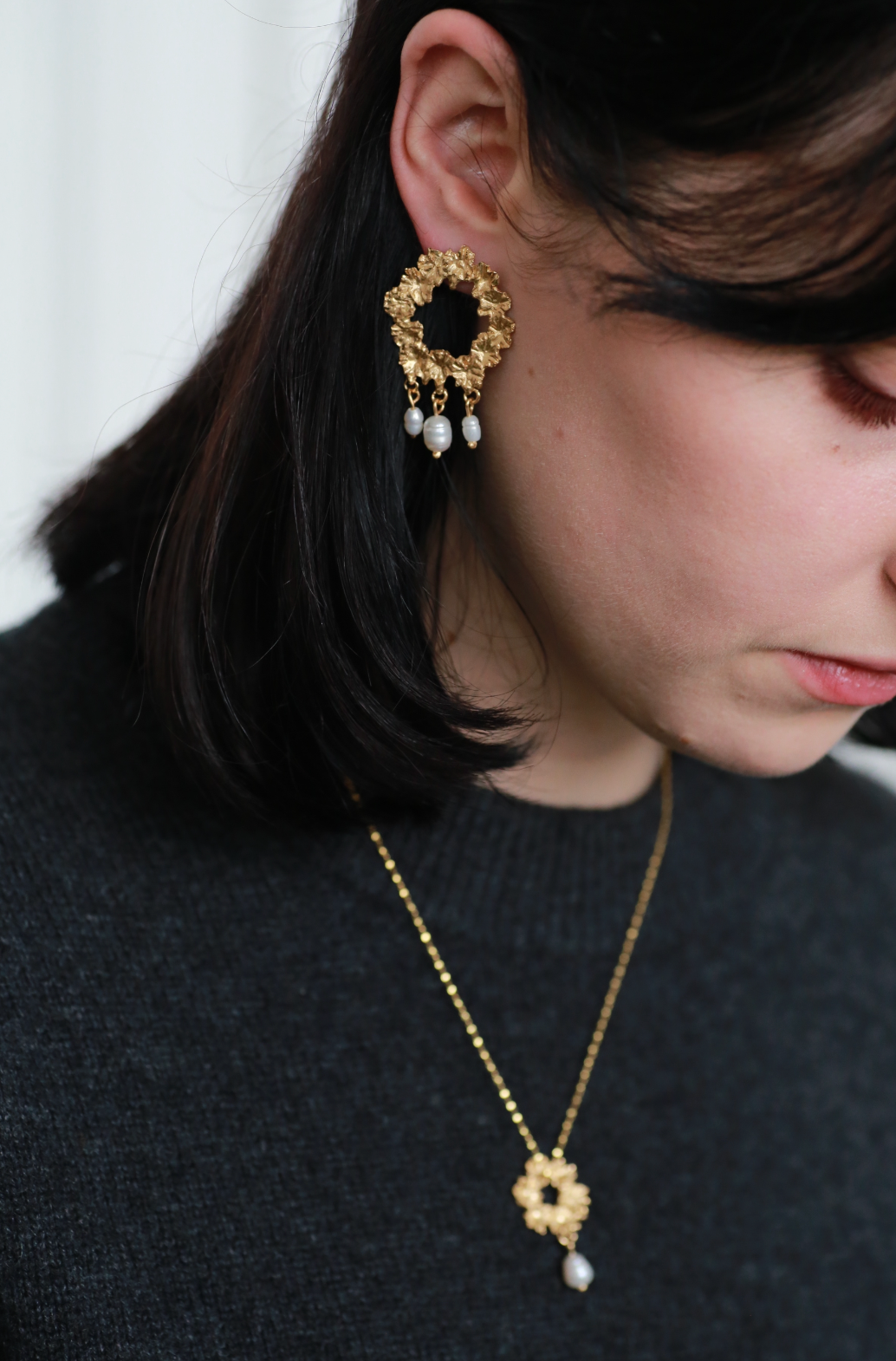 the bee wreath earrings in shot on model gold vermeil