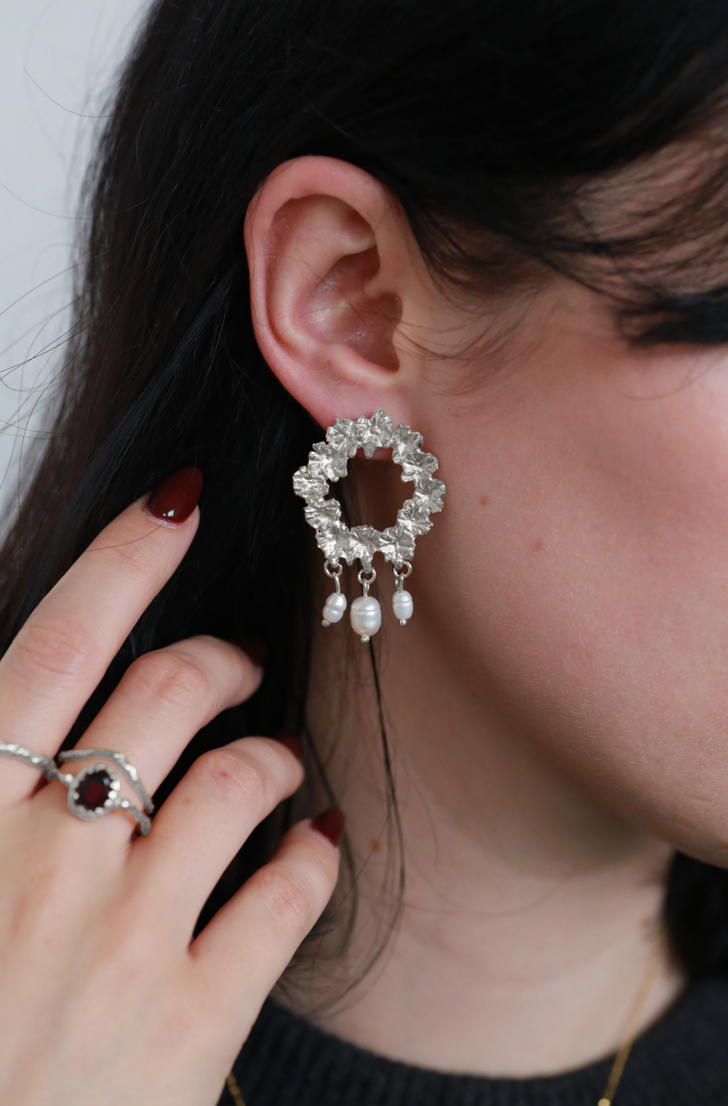 the bee wreath earrings in sterling silver shot on model
