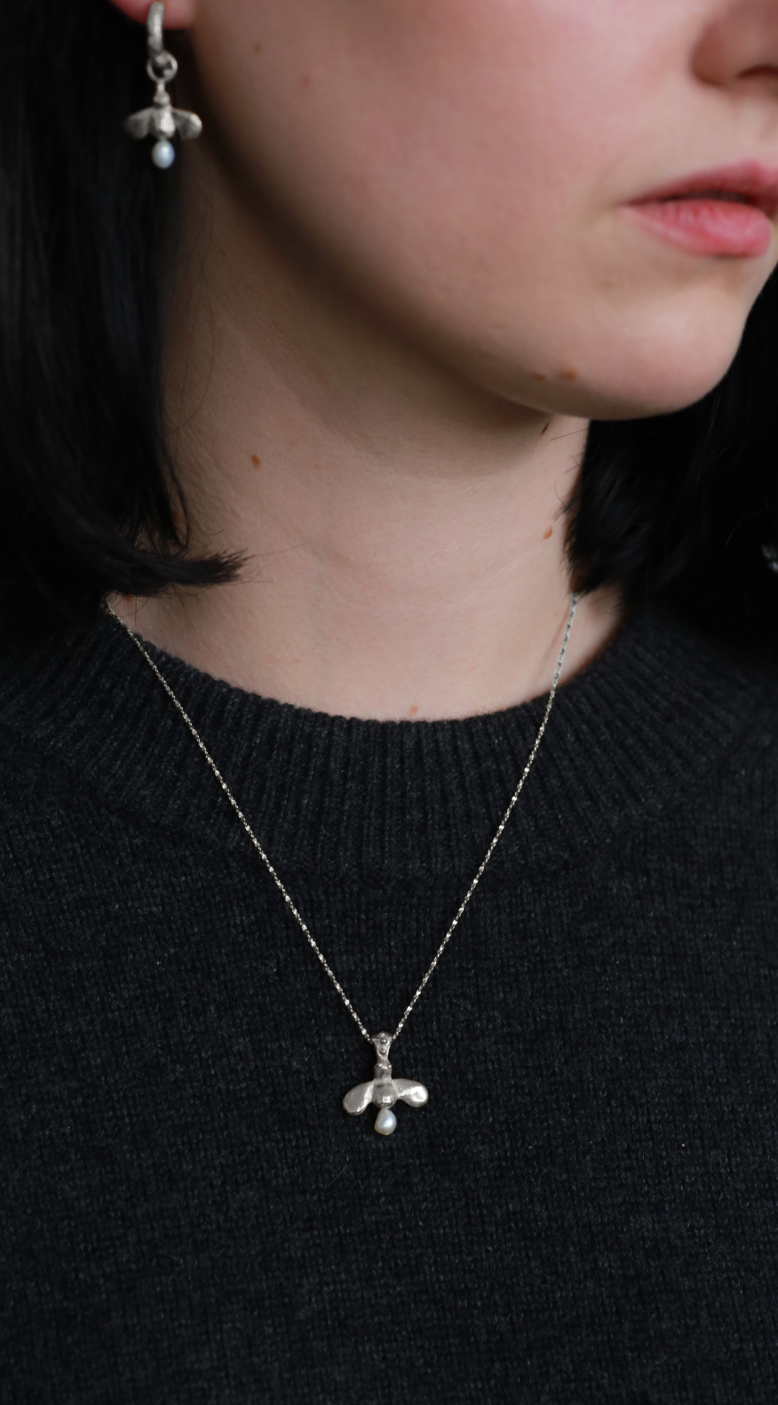 model wears the honey bee drops and the queen bee necklace in sterling silver