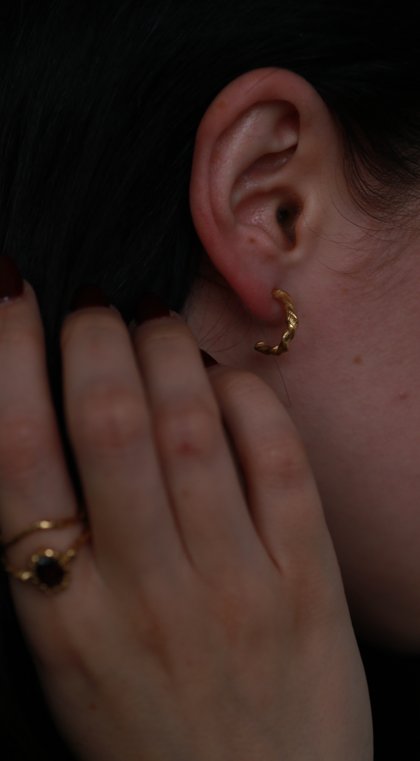 the twisted beeswax hoops gold vermeil model shot with stacking rings